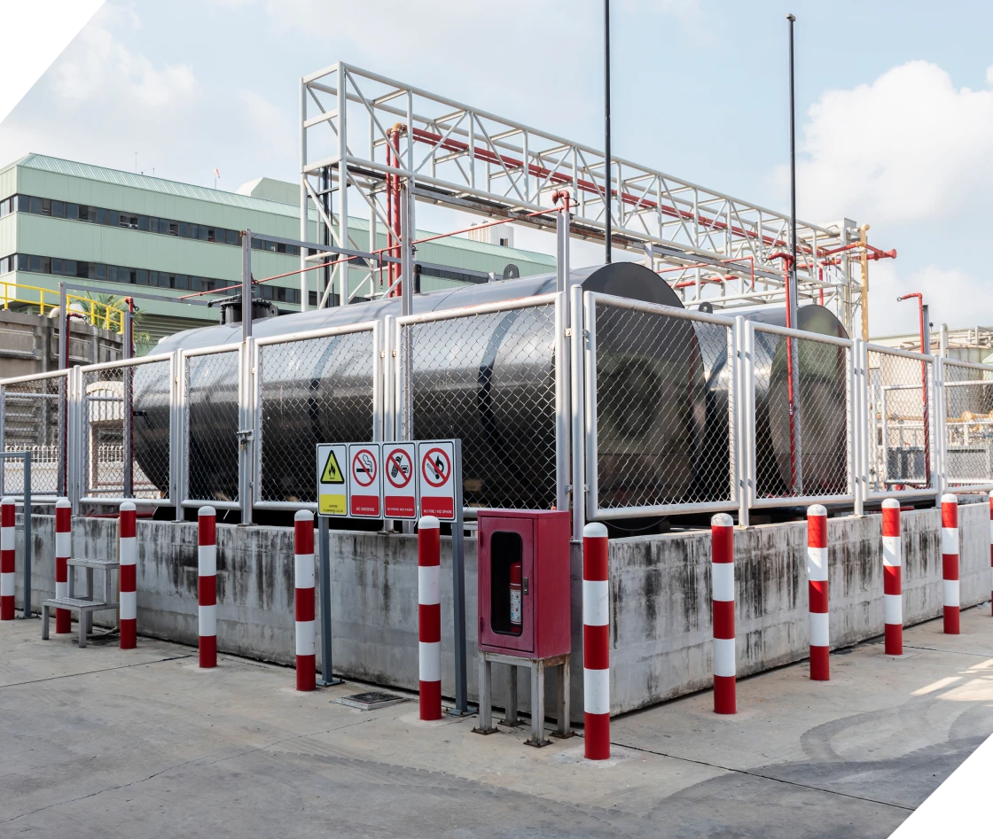 Industrial storage tanks with safety barriers